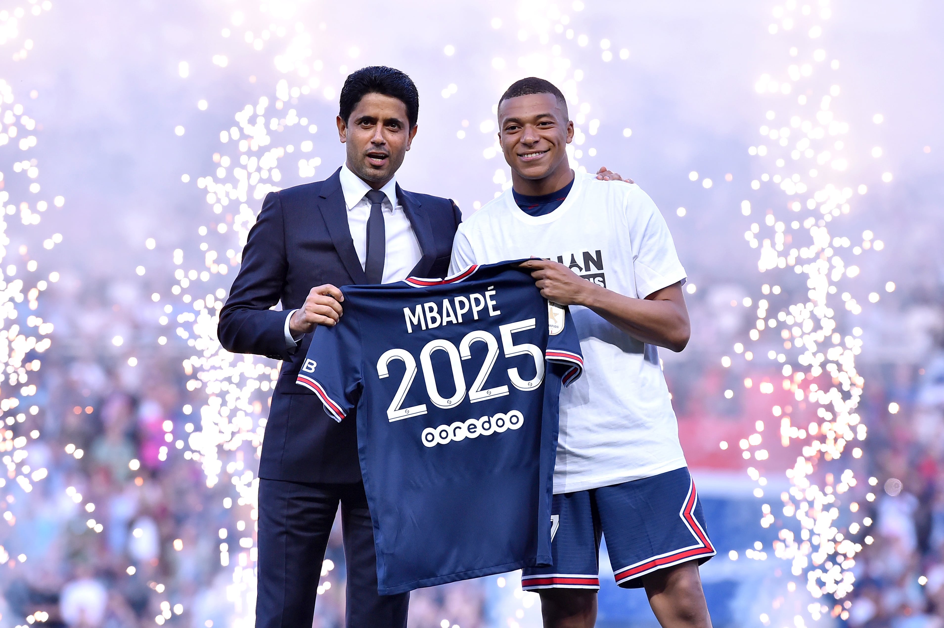 Kylian Mbappé con Nasser Al Khleaïfi y la camiseta de su renovación con el PSG