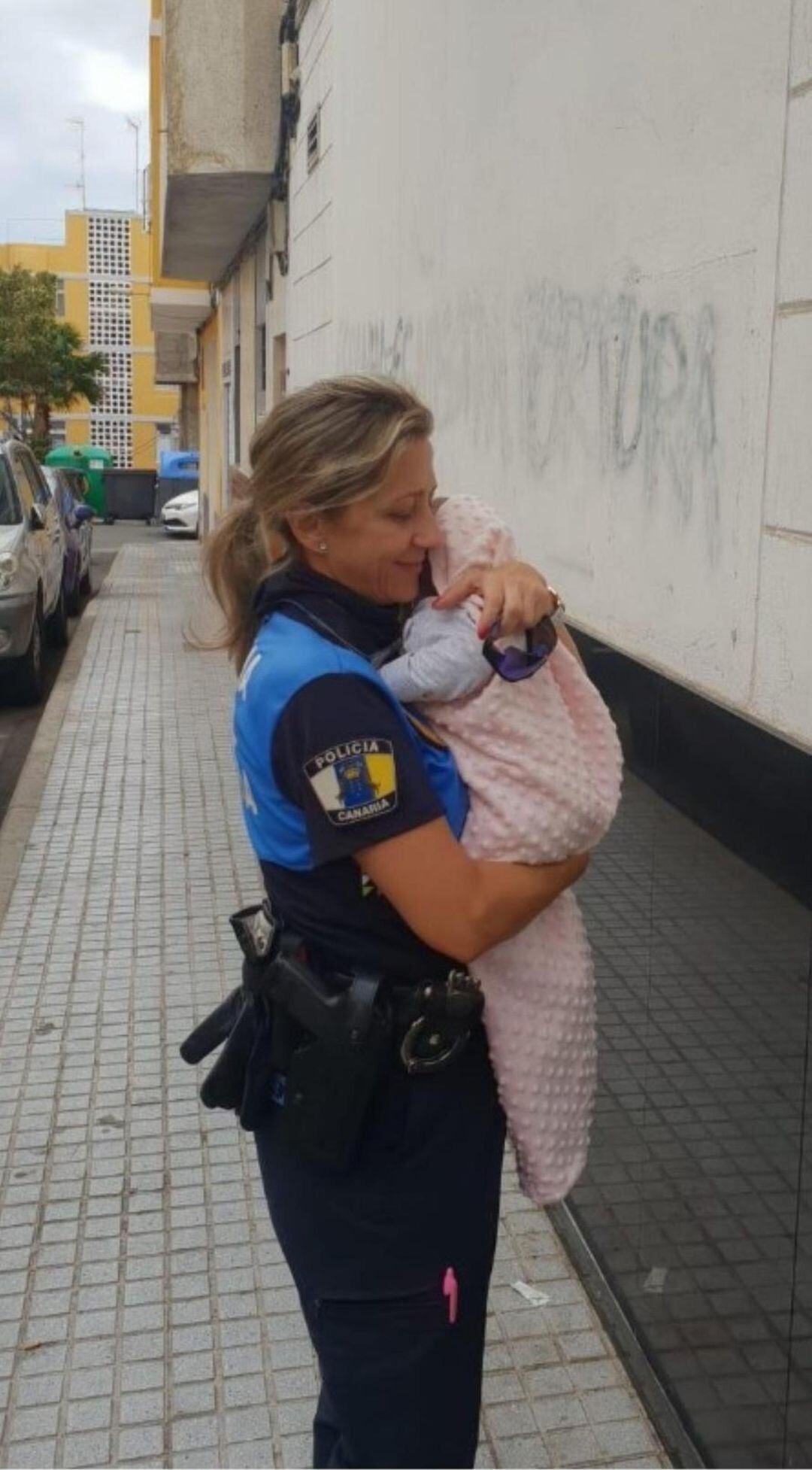 Una de las agentes de la Policía Local con el bebé.