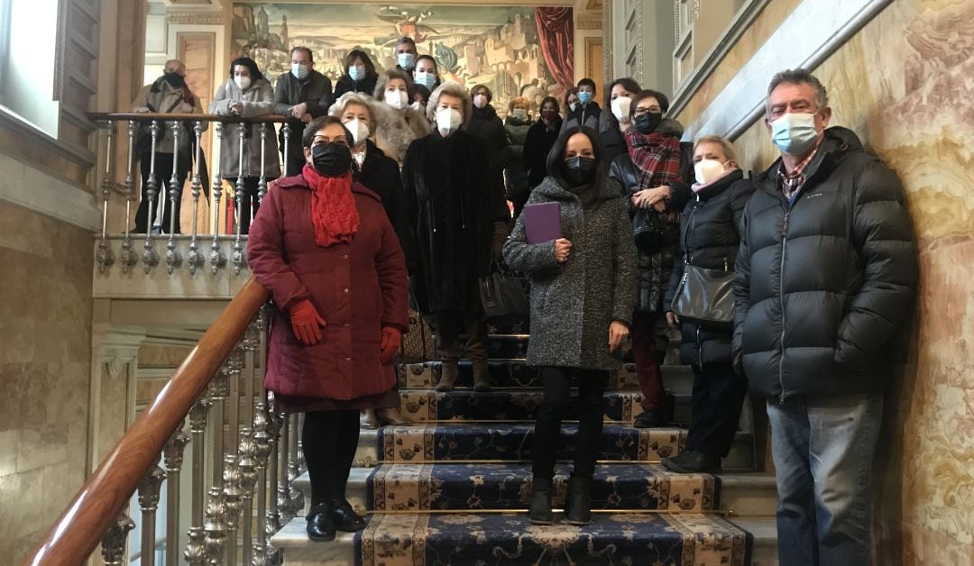 Grupo de visitantes con la guía Laura Higueras en la escalera principal del palacio provincial de la Diputación de Cuenca.