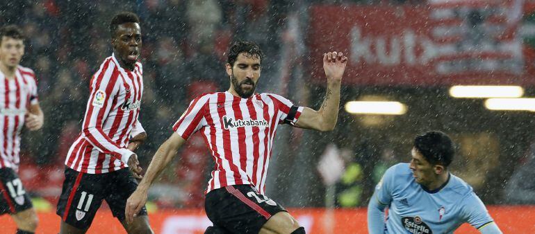 El centrocampista del Athletic de Bilbao, Raúl García (c), controla el balón ante el defensa argentino del Celta de Vigo, Facundo Roncaglia (d), durante el partido de Liga de Primera División correspondiente a la 16 jornada disputado hoy en San Mamés