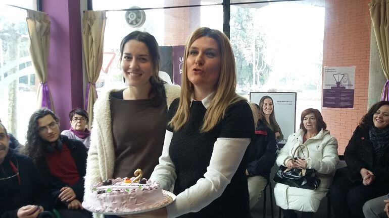 Ana Marcello y Emi Esteban en la sede con la tarta para celebrar el segundo aniversario de Podemos