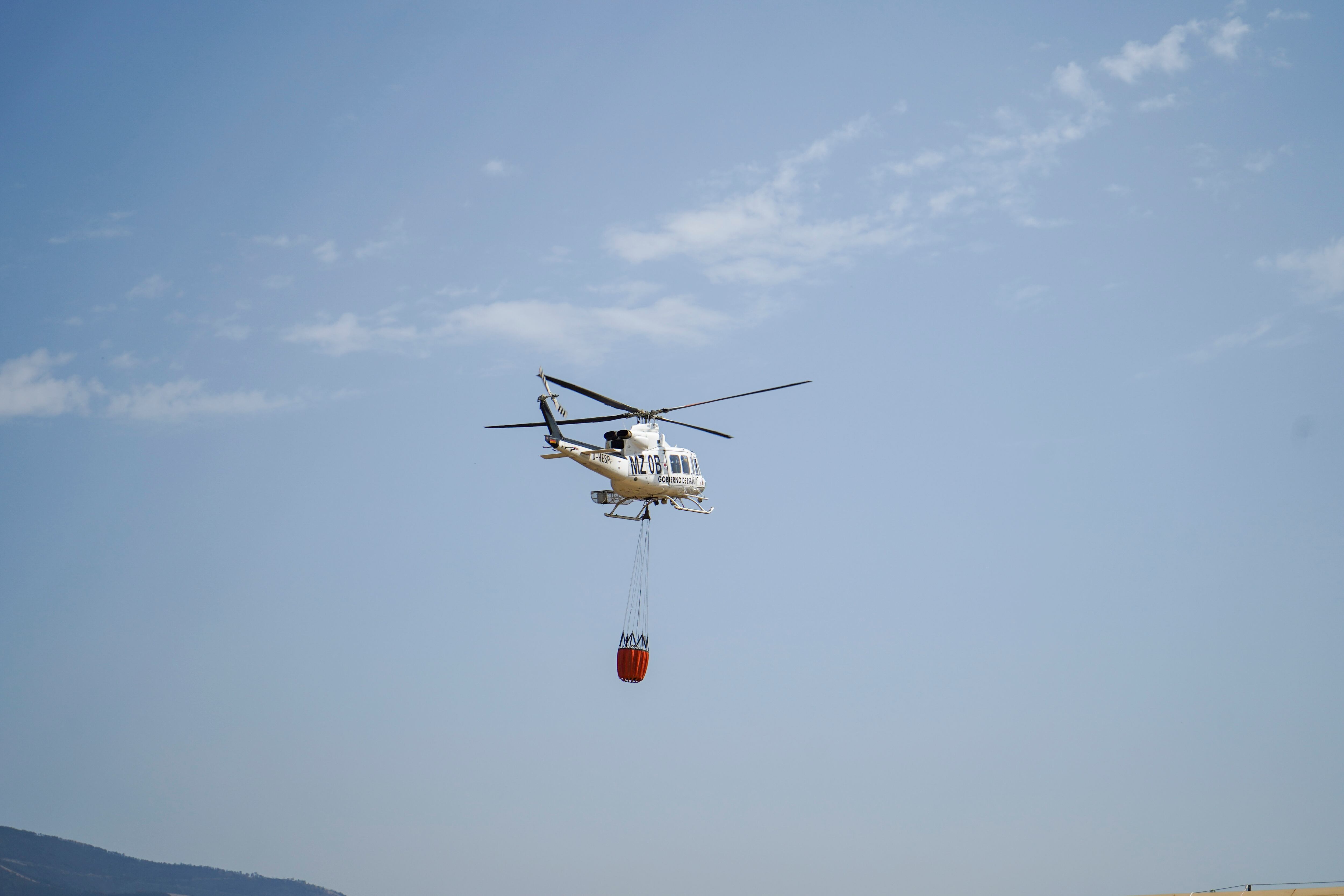 VALDASTILLAS (CÁCERES), 16/08/2025.- Un helicóptero que se dirige al frente de un incendio que avanza hacia Segura de Toro, este sábado. EFE/Eduardo Palomo
