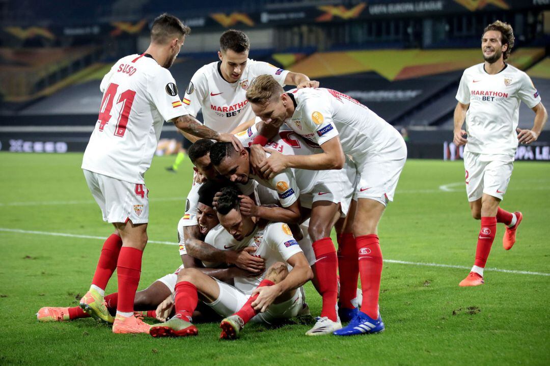 El futbolista del Sevilla, Lucas Ocampos, felicitado por sus compañeros tras marcar el gol del triunfo ante el Wolverhampton