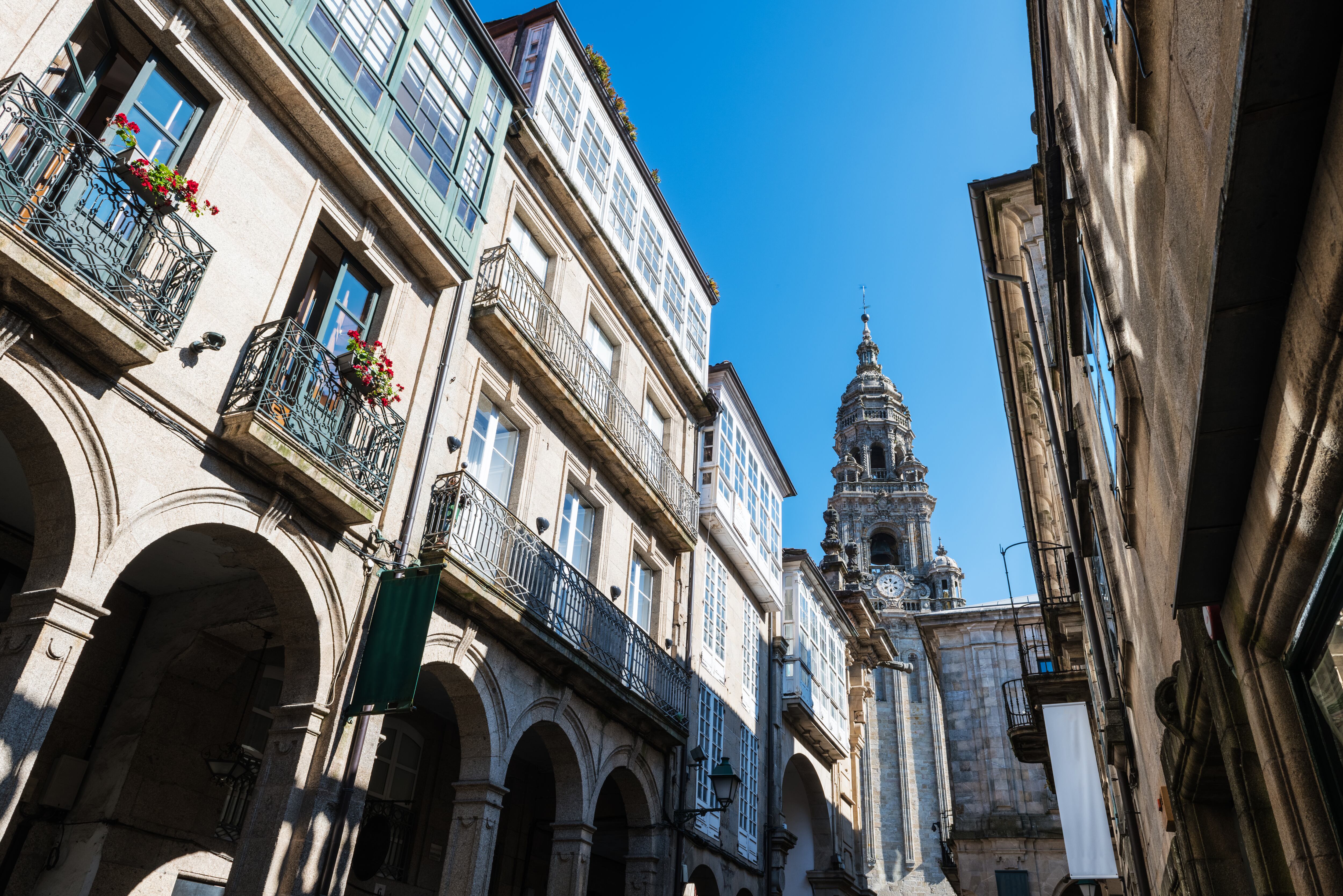 Clock Tower of the famous cathedral of Santiago de Compostela as seen through the narrow streets of the city centre.