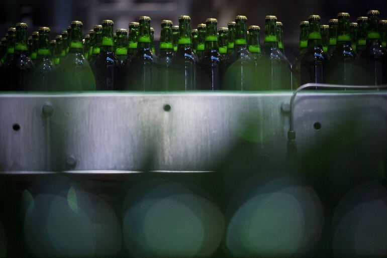 Newly capped bottles of Staropramen beer pass along the production line ahead of labeling at the Pivovary Staropramen A.S. brewing company, operated by Molson Coors Brewing Co., in Prague, Czech Republic, on Tuesday, Nov. 4, 2014. Molson Coors bought StarBev LP, which operates nine breweries in central and eastern Europe including the Czech Republic, the home of Prague-based Staropramen, as well as Hungary, Romania and Bulgaria from CVC Capital Partners Ltd. for 2.65 billion euros ($3.5 billion) in April 2012. Photographer: Martin Divisek/Bloomberg