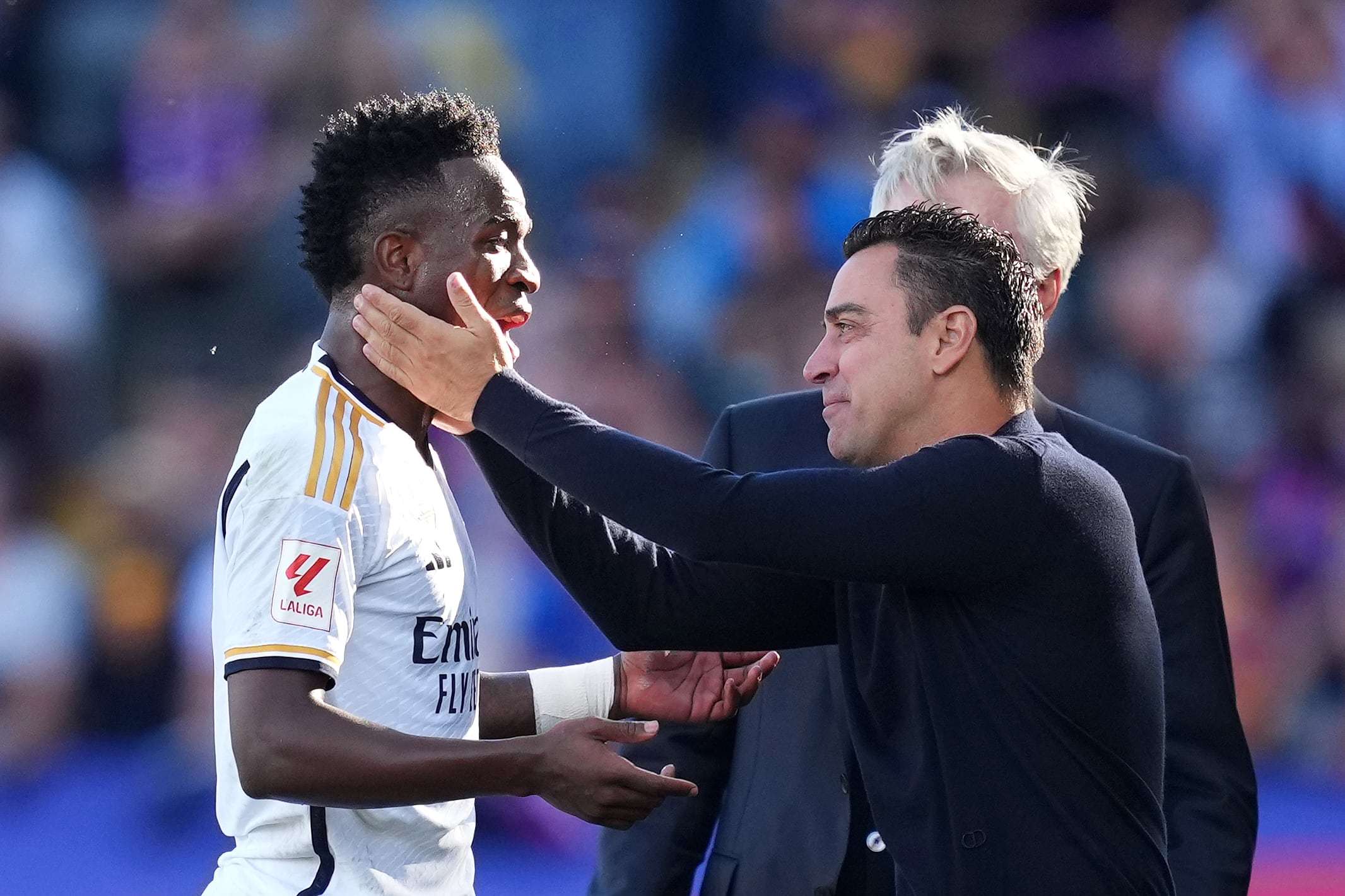 BARCELONA, SPAIN - OCTOBER 28: Xavi, Head Coach of FC Barcelona, embraces Vinicius Junior of Real Madrid during the LaLiga EA Sports match between FC Barcelona and Real Madrid CF at Estadi Olimpic Lluis Companys on October 28, 2023 in Barcelona, Spain. (Photo by Alex Caparros/Getty Images)