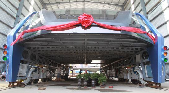 A model of a innovative street-straddling bus called Transit Elevated Bus is seen after a test run in Qinhuangdao, Hebei Province, China, August 3, 2016. The test bus currently consists of one segment, and is capable of carrying 300 people, according to l