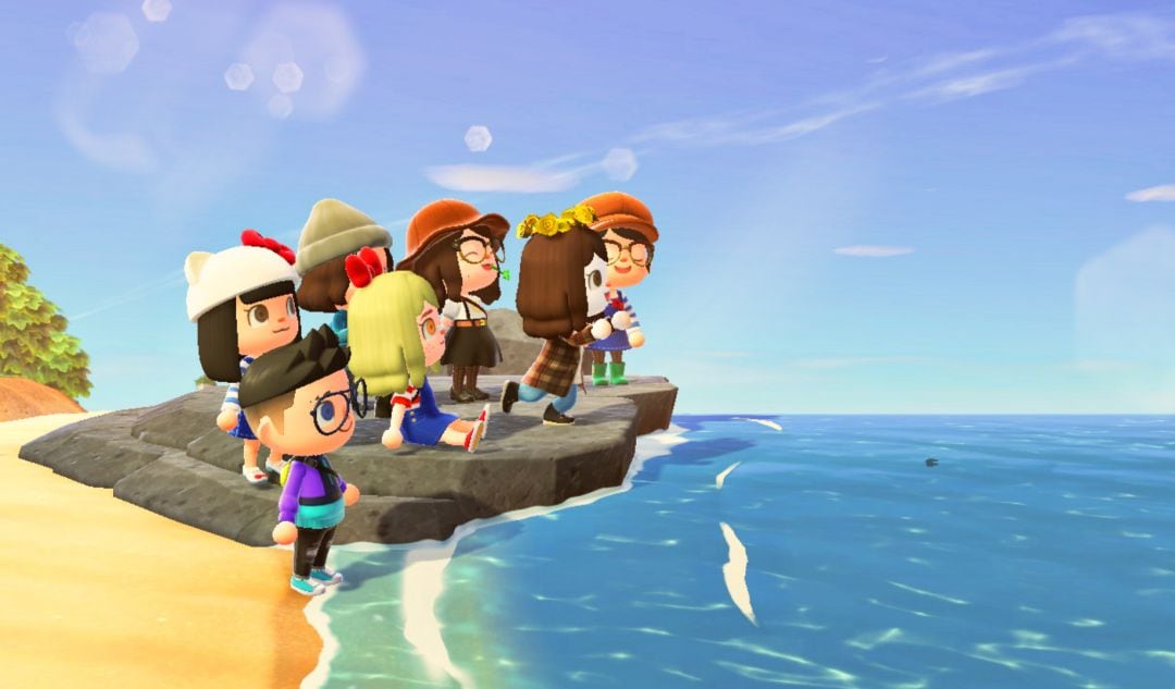 Grupo de amigos en la playa de una isla de Animal Crossing: New Horizons.