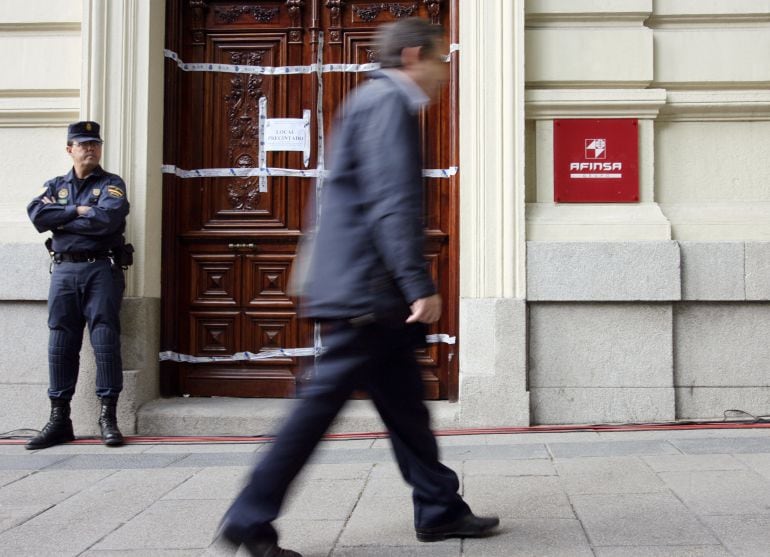 Un agente de policía monta guardia frente a las oficinas de Afinsa