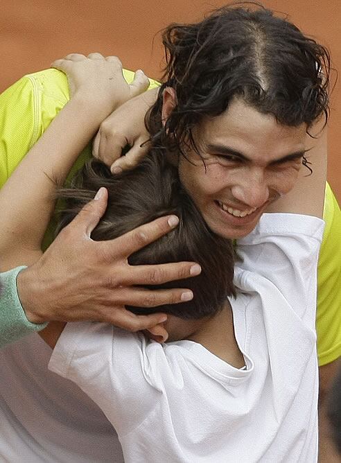 Nadal celebra con un niño, que saltó a la pista a felicitarle, su sufrido triunfo ante Djokovic