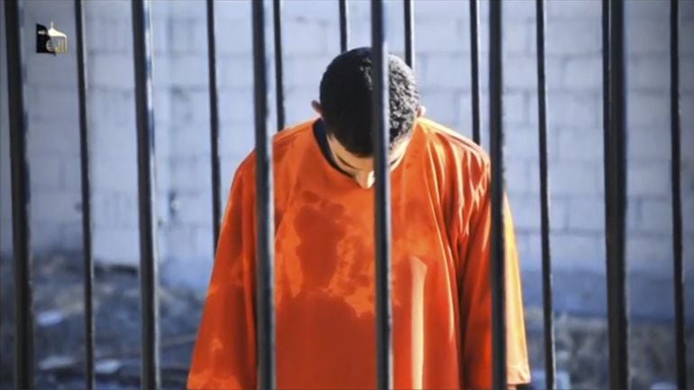 A man purported to be Islamic State captive Jordanian pilot Muath al-Kasaesbeh is seen standing in a cage in this still image from an undated video filmed from an undisclosed location made available on social media on February 3, 2015. Islamic State milit