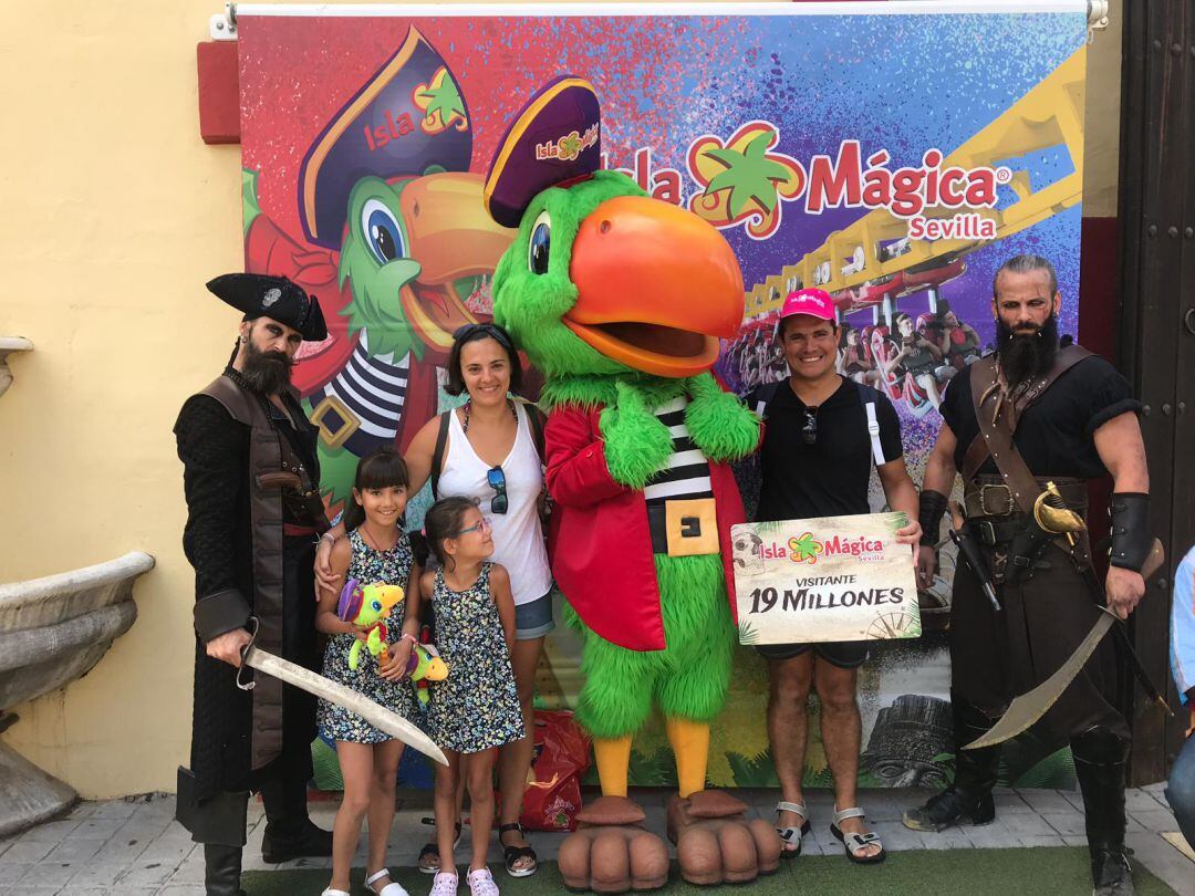 Irune, visitante número 19 millones  de Isla Mágica, junto a personajes del parque, su hermana, y sus padres Clemente y María