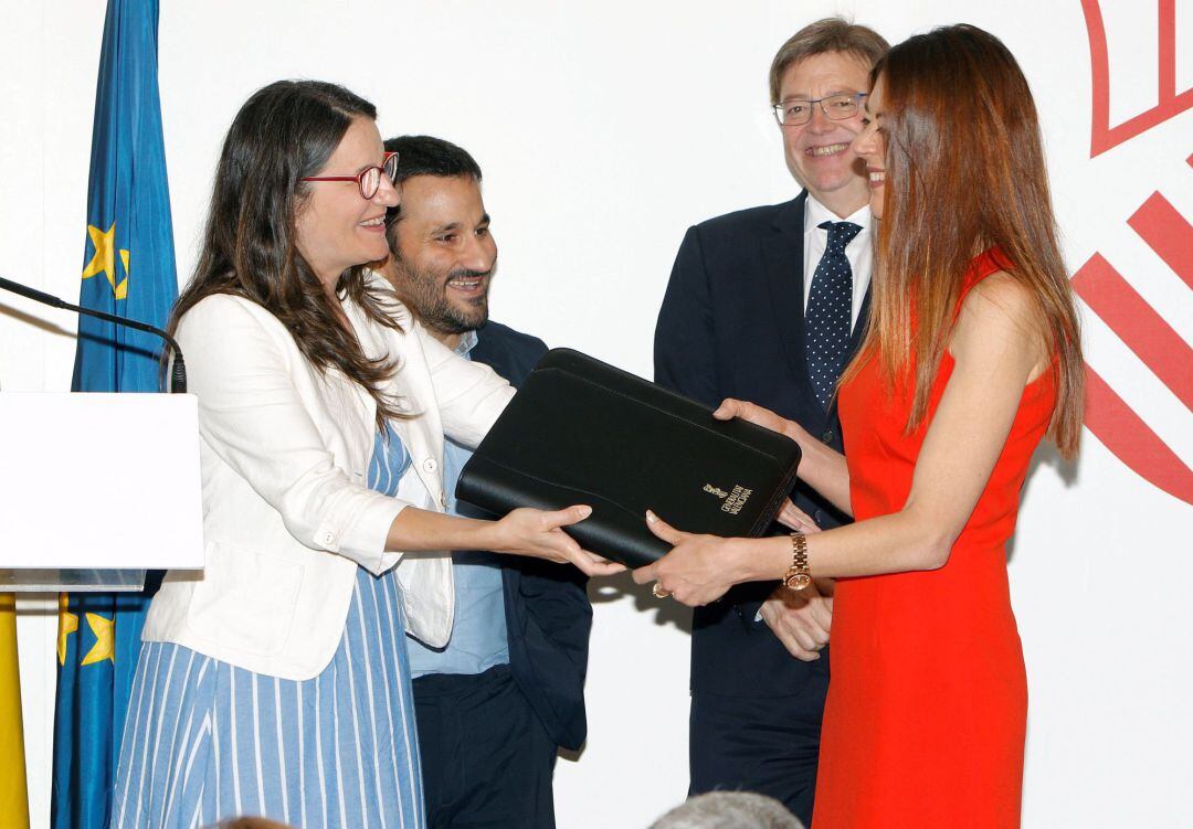 La vicepresidenta del Consell Mónica Oltra (izqda), entrega el manual &quot;del buen gobierno&quot; a la consellera de Innovación, Universidades, Ciencia y Sociedad Digital, Carolina Pascual, ante el president de la Generalitat, Ximo Puig, y el conseller de Educación, Vicent Marzá