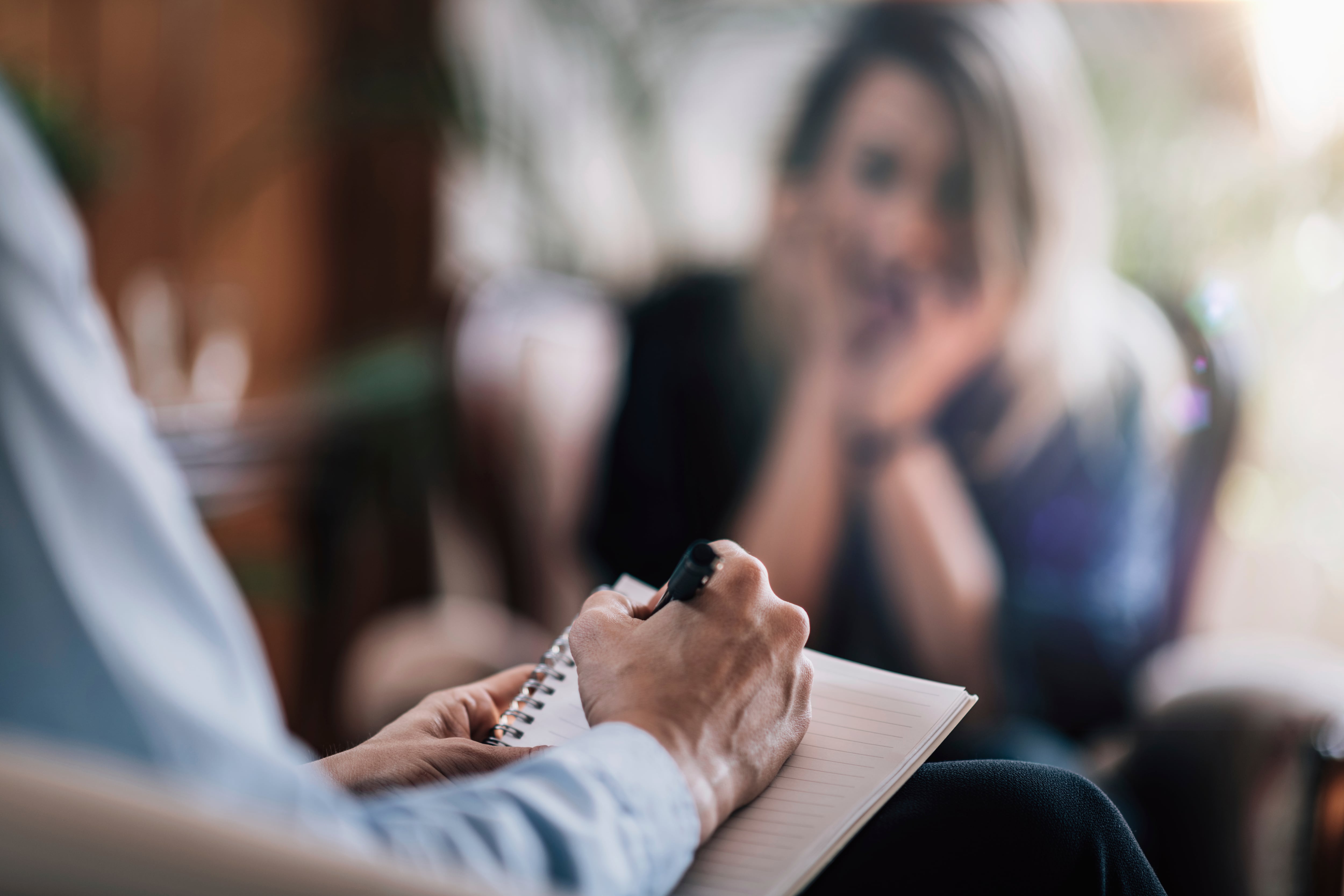 Psychology therapy session. Female patient talking to mental health professional.