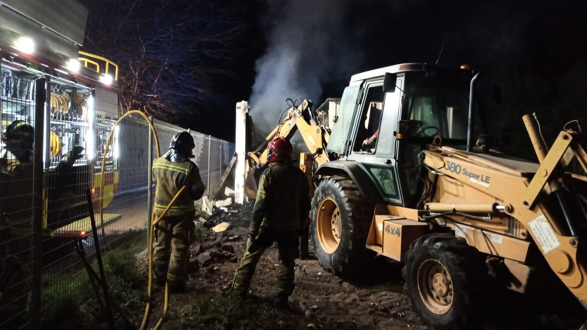 Los bomberos trabajan en extinguir el fuego que afectó a un camión