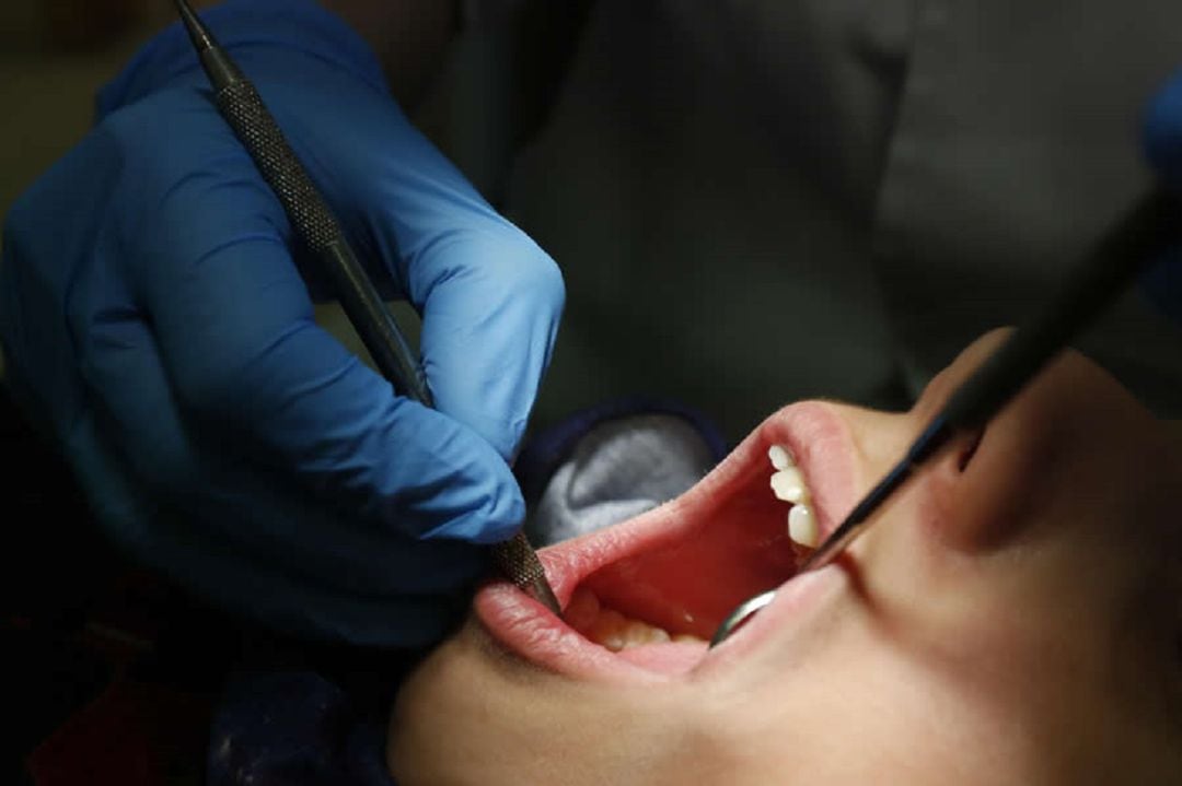 Un dentista realiza una revisión bucodental.