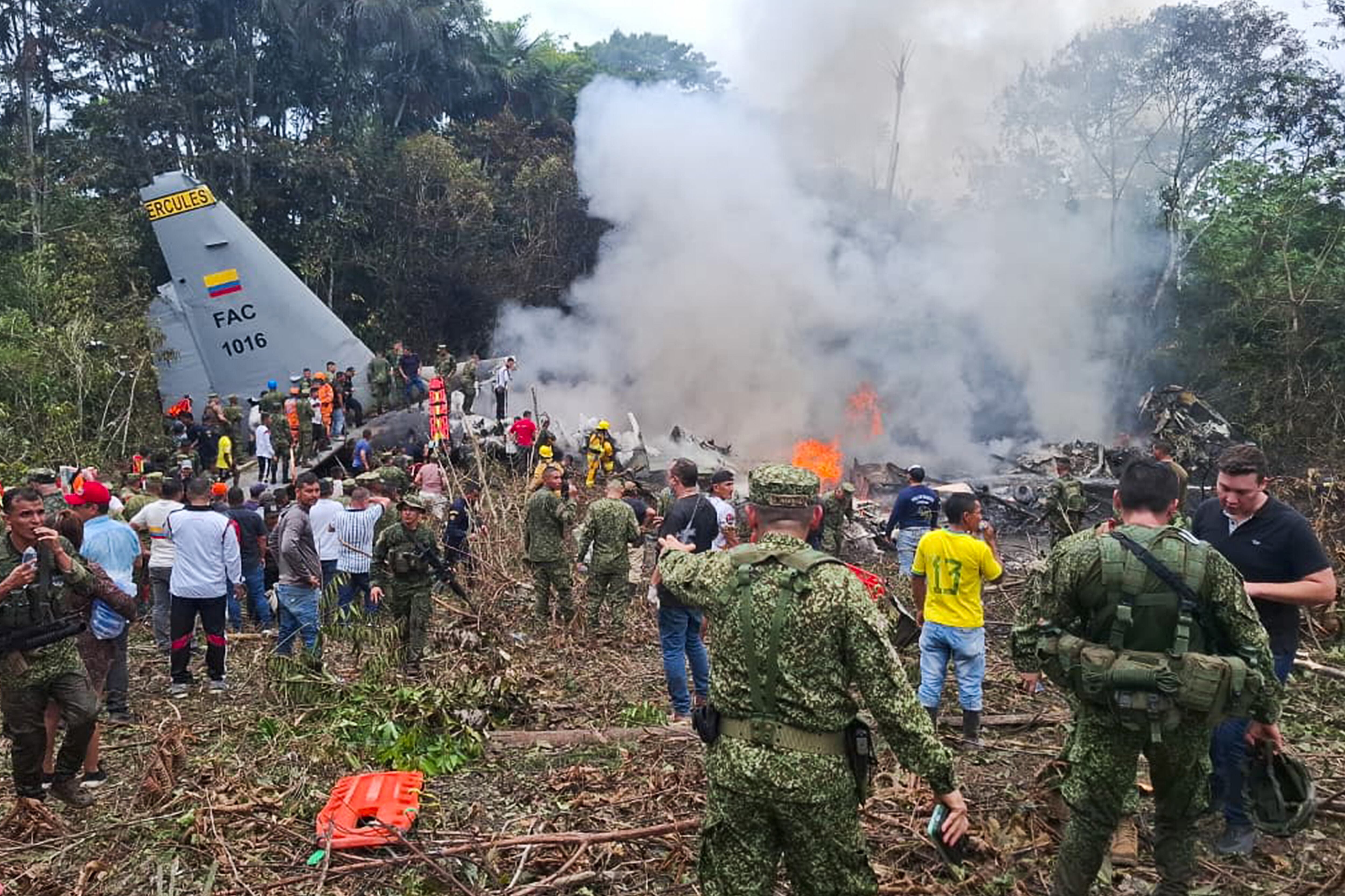 Integrantes de las Fuerzas Militares de Colombia, rescatistas y voluntarios realizan labores de rescate este lunes, en Puerto Leguizamo (Colombia).