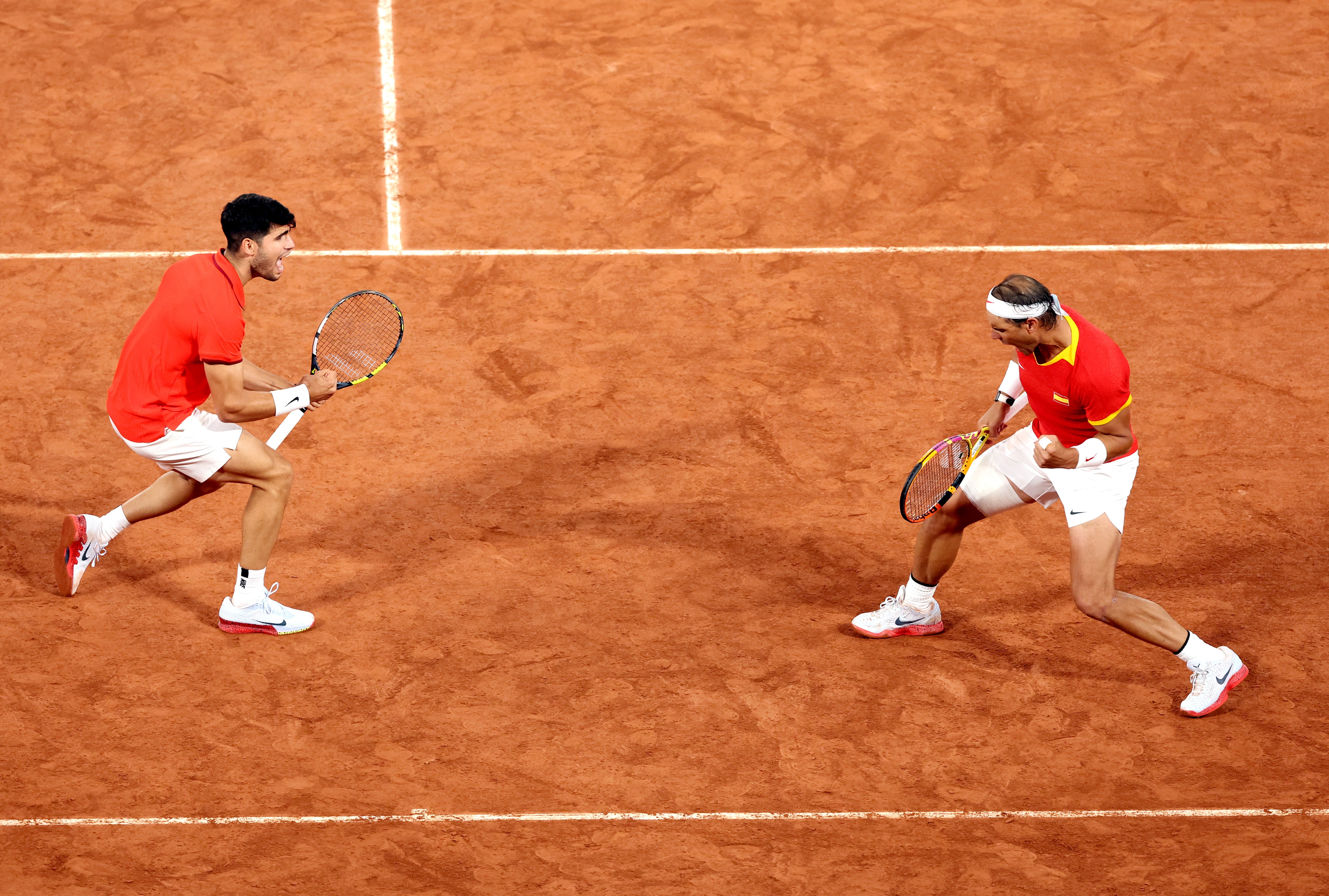 PARIS, FRANCE - JULY 27: Rafael Nadal (R) and partner Carlos Alcaraz of Team Spain celebrate against Andres Molteni and Maximo Gonzalez of Team Argentina during the Men&#039;s Doubles first round match on day one of the Olympic Games Paris 2024 at Roland Garros on July 27, 2024 in Paris, France. (Photo by Matthew Stockman/Getty Images)