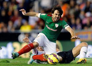 Beñat Etxebarria y el centrocampista del Valencia Javi Fuego durante el partido correspondiente a la undécima jornada de Liga de Primera División que disputan en el estadio Mestalla de Valencia.