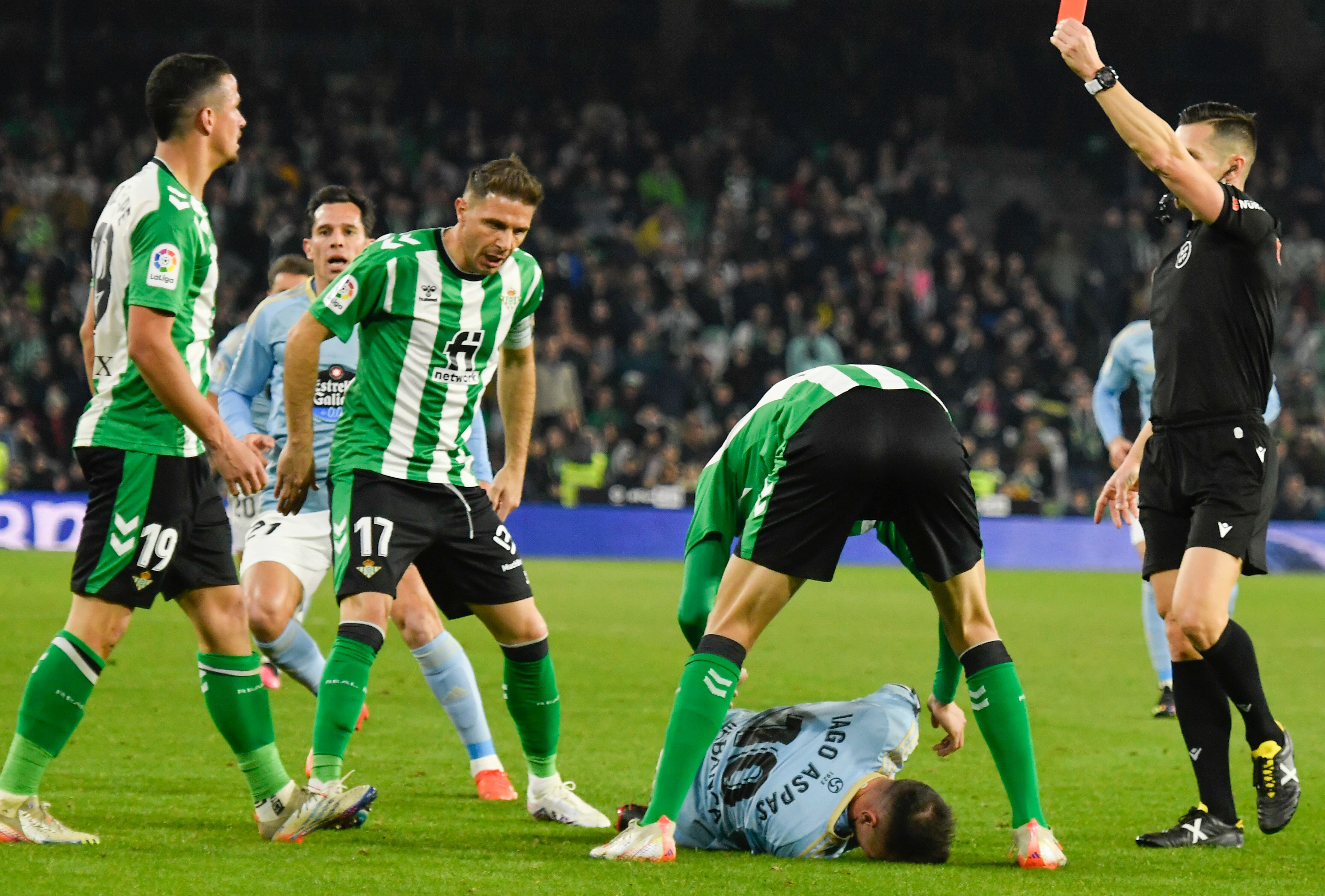 SEVILLA, 04/02/2023.- El colegiado Del Cerro Grande saca tarjeta roja directa a Luiz Felipe (i), del Real Betis, por su entrada a Iago Aspas, del Celta de Vigo, durante el partido de la jornada 20 de la Liga Santander que Real Betis y Celta de Vigo disputan este sábado en el estadio Benito Villamarín, en Sevilla. EFE/ Raúl Caro.
