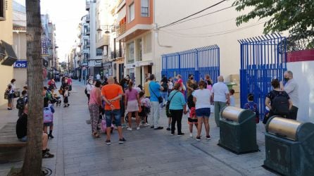 Grupos de gente a las puetas de un colegio de Gandia