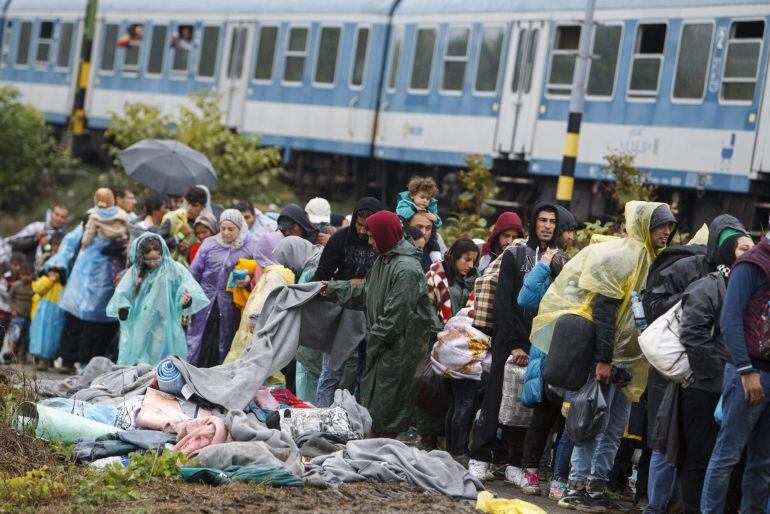 Agentes de policía controlan el acceso de los refugiados procedentes de Croacia al tren en Zakany, a 230 kilómetros de Budapest, Hungría