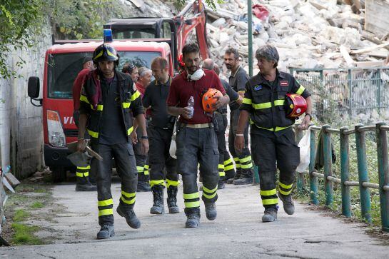 PERUGIA, ITALY - AUGUST 25: Fire fighters rest at Pescara del Tronto on August 25, 201 in Perugia, Italy. Central Italy was struck by a powerful, 6.2-magnitude earthquake in the early hours, which has killed at least three people and devastated dozens of 