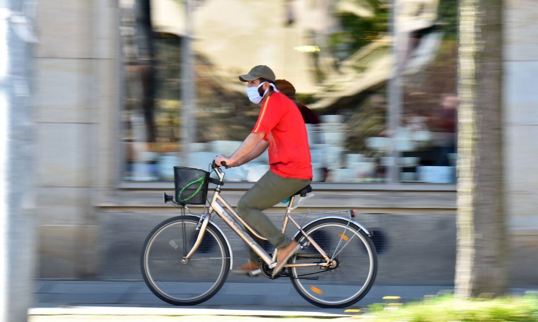 Un ciclista paseando por una calle de la ciudad 