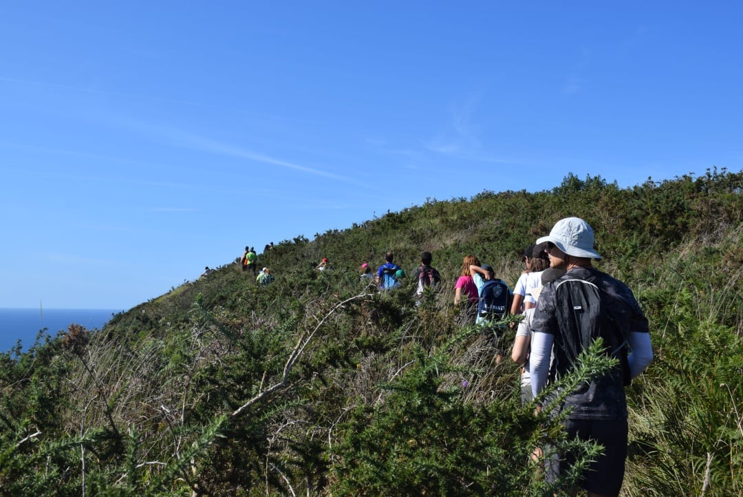 Excursionistas subiendo el monte en una de las rutas guiadas