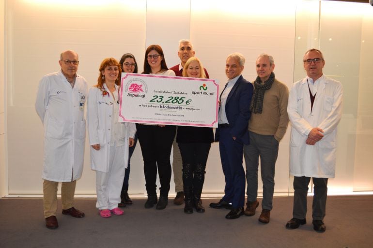 Responsables de Sport Mundi, ASPANOGI y Bio Donostia con el cheque recibido, cuyos fondos irán a la investigación del cáncer infantil. 