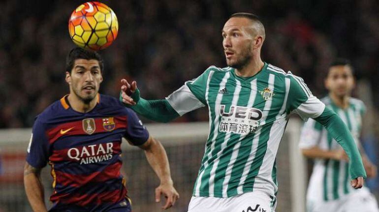 Didier Digard controla el balón ante la mirada de Luis Suárez