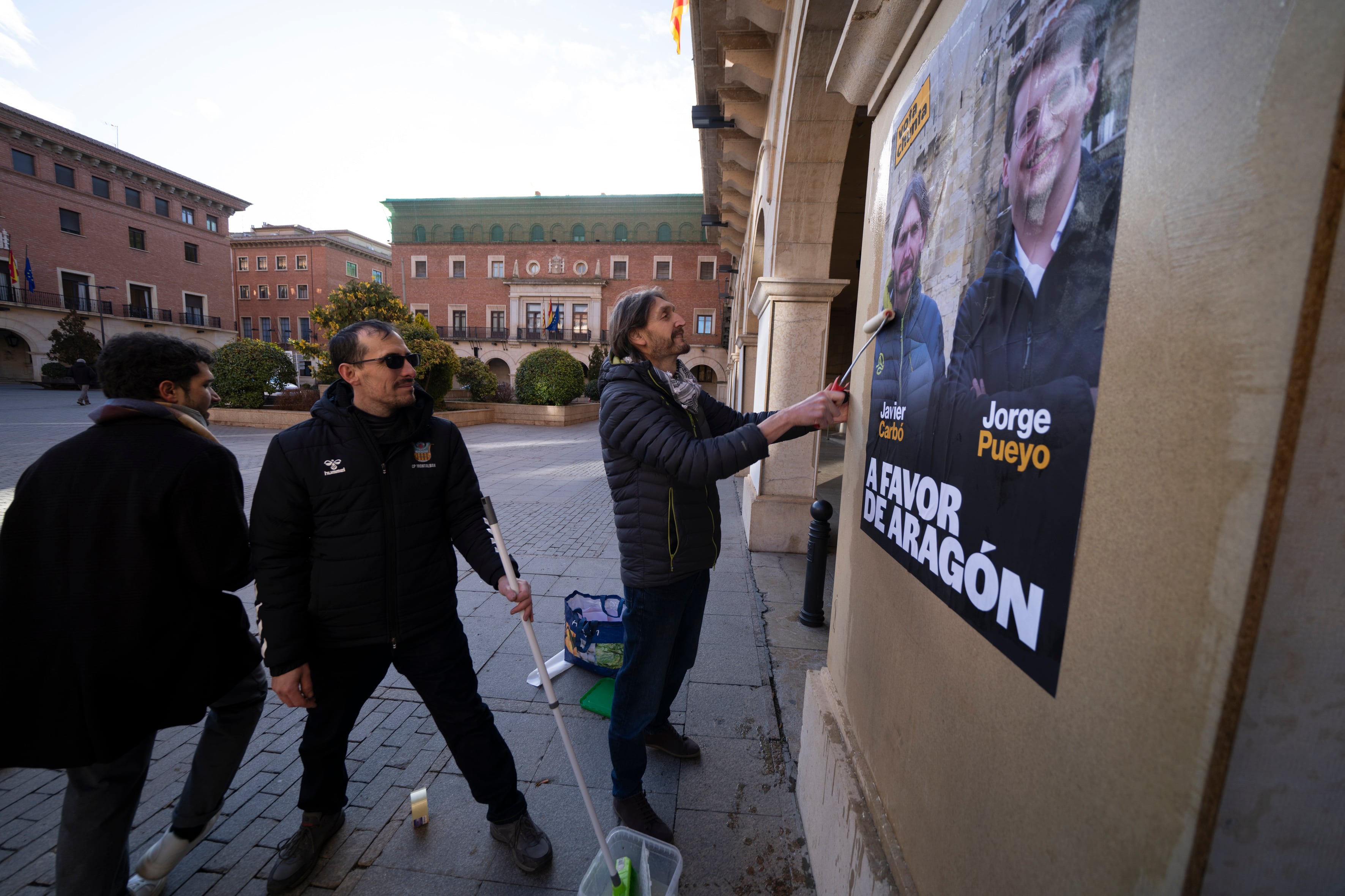 TERUEL, 23/01/2026.- Javier Carbó, numero uno de la lista de Teruel por Chunta Aragonesista, durante la tradicional tradicional pegada de carteles electorales de los partidos políticos, este viernes en la plaza San Juan de Teruel. EFE/Antonio García