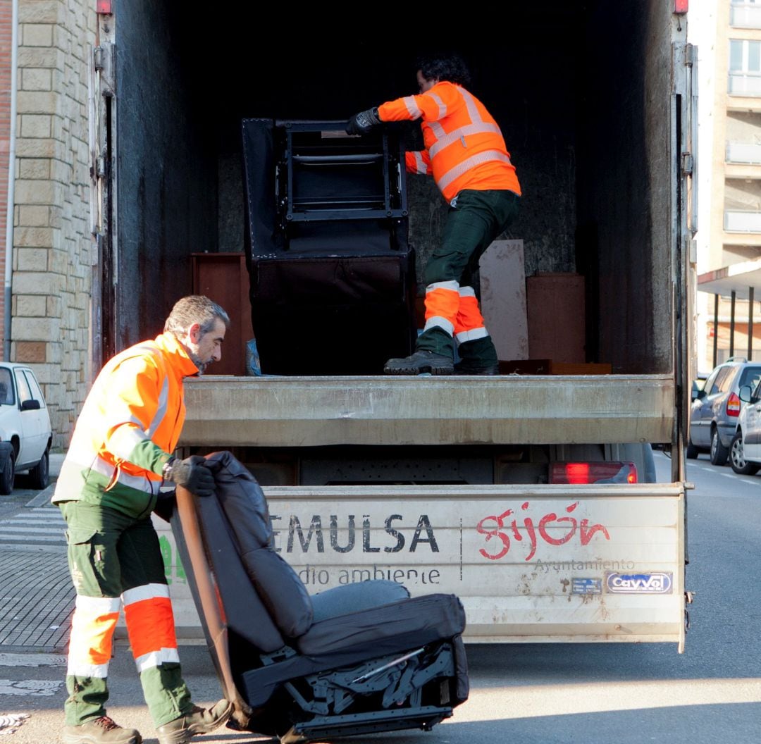 Dos operarios transportando muebles. 