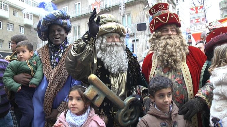 Los Reyes Magos posan con algunos niños a su llegada a la ciudad de Vigo.