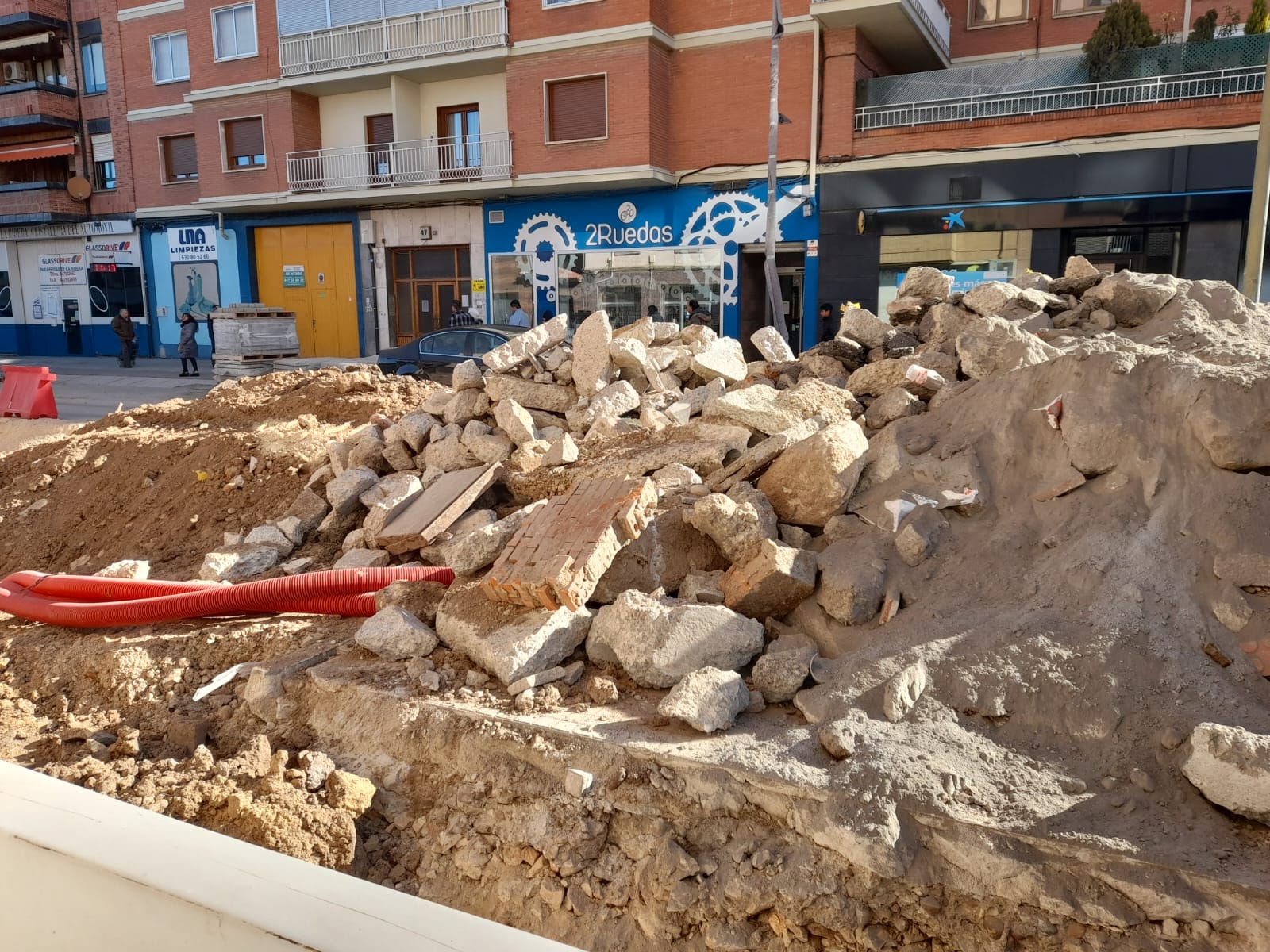 Escombrera en la Avenida Castilla de Aranda con pedazos de tuberías seccionadas, polvo resultante de las obras y otros desechos