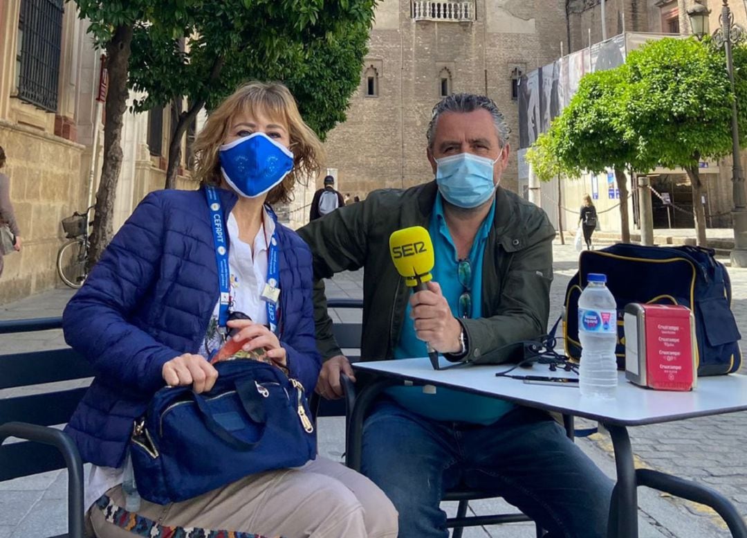 Ana López atiende al micrófono de Paco García a los pies de la Giralda