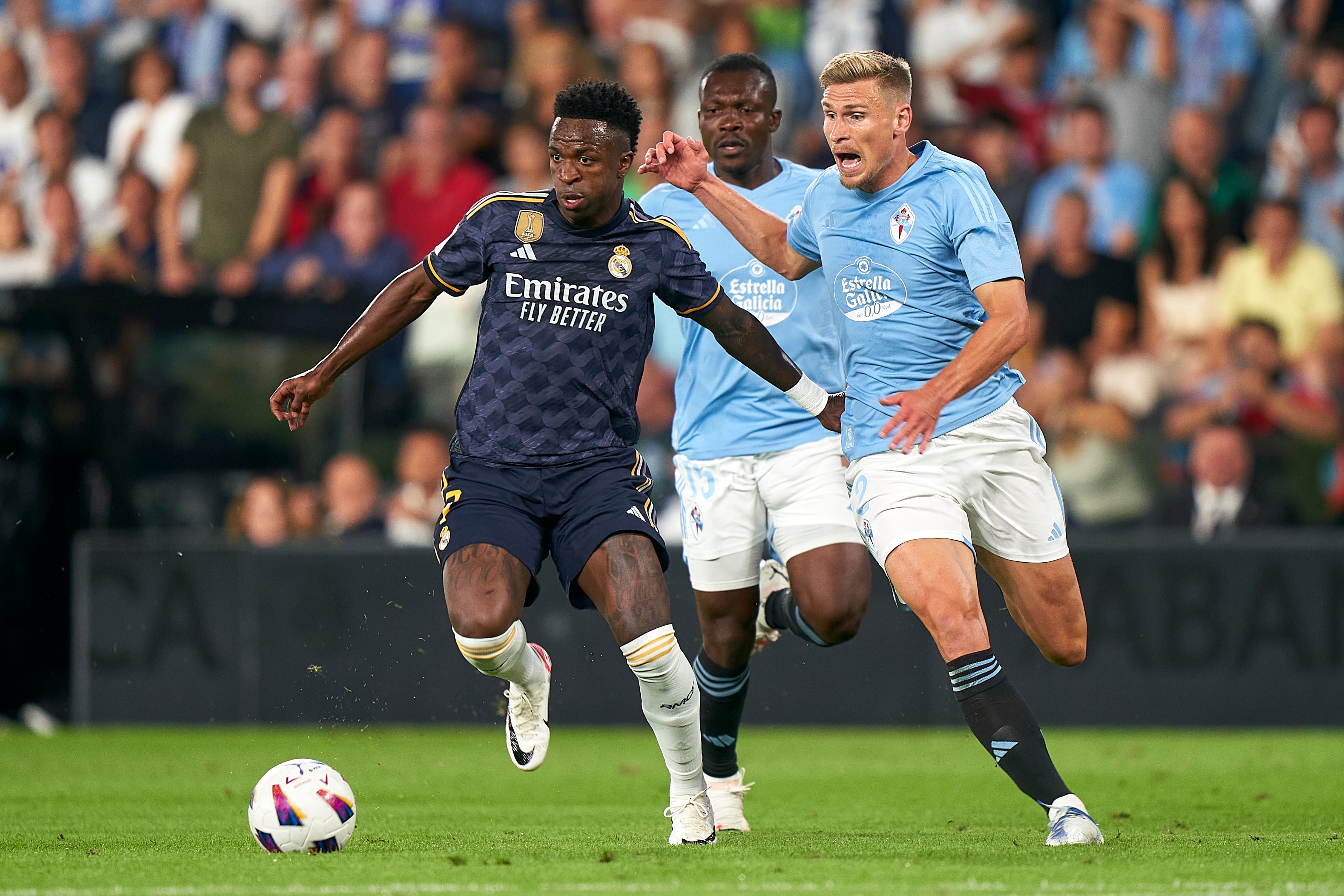 VIGO, SPAIN - AUGUST 25:  Carl Starfelt of RC Celta de Vigo competes for the ball with Vinicius Junior of Real Madrid during the LaLiga EA Sports match between RC Celta Vigo and Real Madrid CF at Estadio Abanca Balaidos on August 25, 2023 in Vigo, Spain. (Photo by Jose Manuel Alvarez/Quality Sport Images/Getty Images)