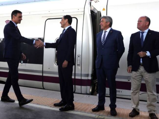 El presidente del Gobierno en funciones, Pedro Sánchez (i), saluda al presidente de la Junta, Juanma Moreno (d), en la parada realizada en la localidad malagueña de Antequera, en el viaje inaugural de este AVE Madrid-Antequera-Granada, que recorrerá en poco más de tres horas los 568 kilómetros que separan ambas ciudades, lo que supondrá que la ciudad granadina estará conectada a la Alta Velocidad con la entrada en servicio de tres circulaciones diarias por sentido con la capital de España