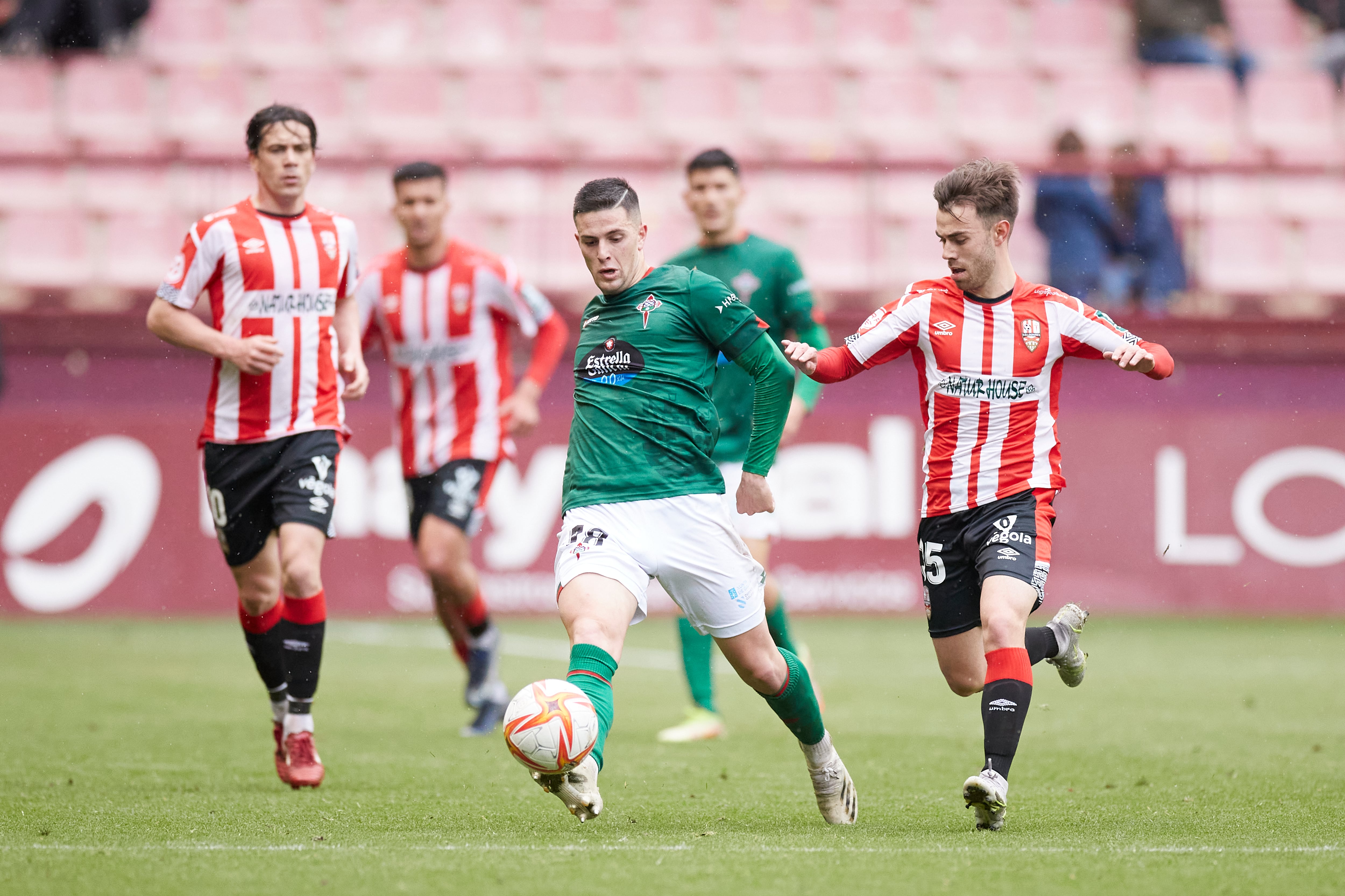 David del Pozo conduce el esférico entre rivales durante el Unión Deportiva Logroñés-Racing en Las Gaunas