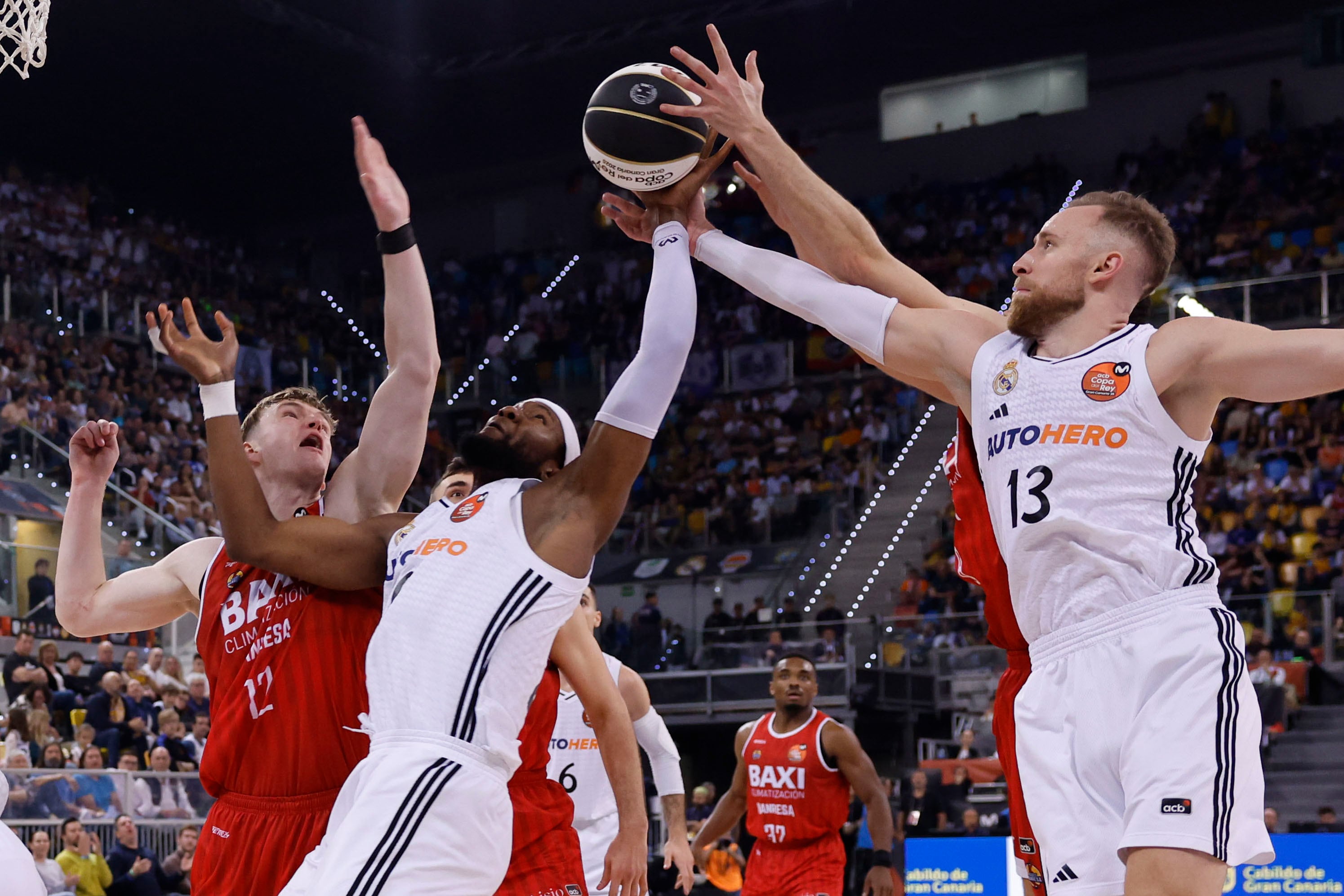 Los jugadores del Real Madrid Bruno Fernando y Dzanan Musa luchan el balón con el letón Marcis Steinbergs del Baxi Manresa