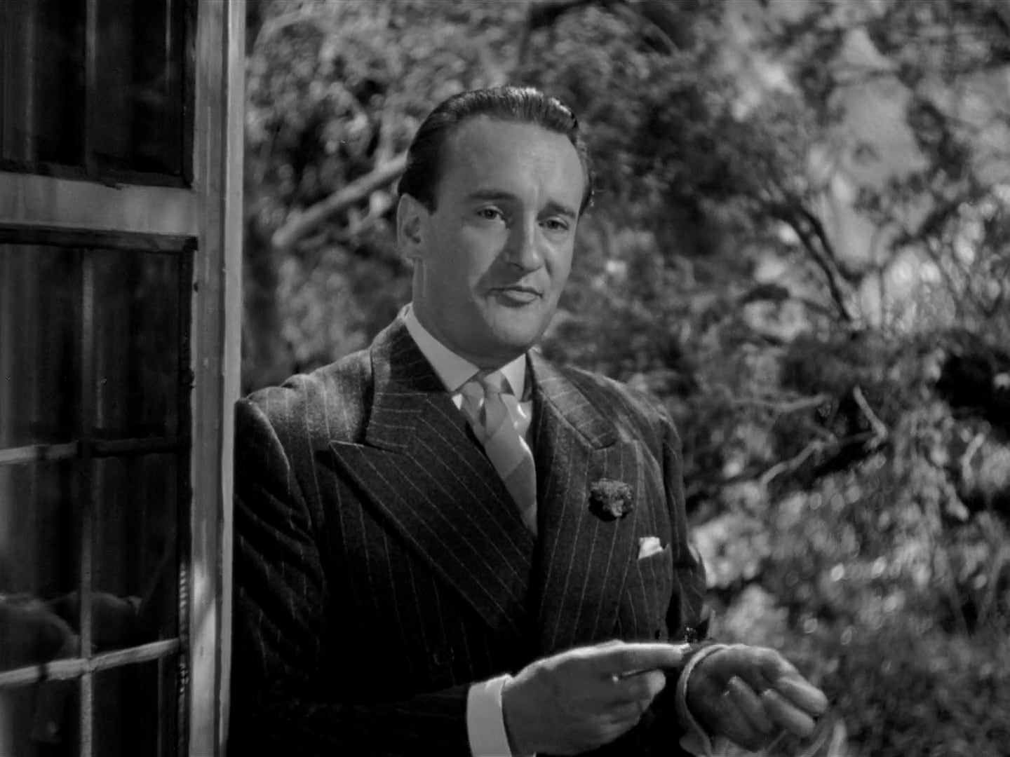 George Sanders interpretando a Jack Favell en Rebeca, de Alfred Hitchcock