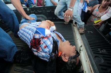 Demonstrators help an injured man during a protest against Nicaraguan President Daniel Ortega&#039;s government in Managua