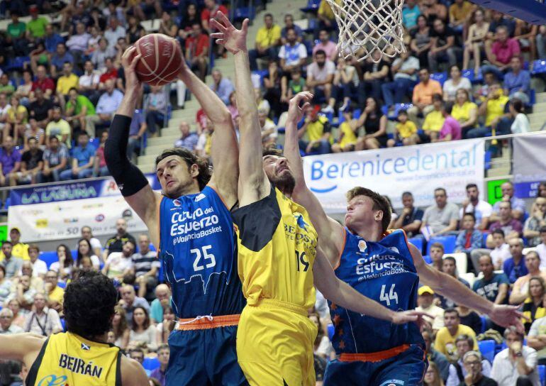GRA358. LA LAGUNA (TENERIFE), 10/05/2015.- Los pívots del Valencia Basket Kresimir Loncar (i) y Luke Harangody (d) luchan por el balón con el pívot griego del Iberostar Tenerife Fotios Lampropoulos durante el partido de la trigésimo segunda jornada de Liga que disputan en La Laguna. EFE/Cristóbal García