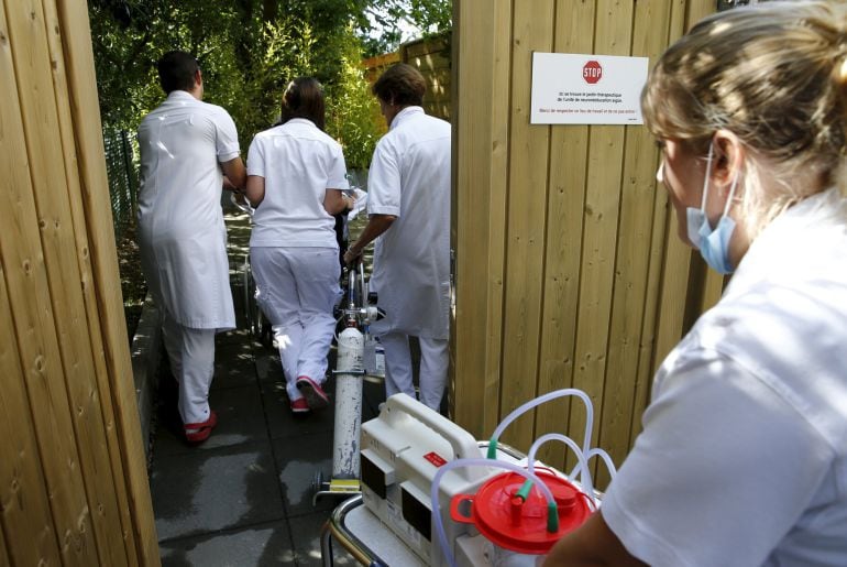 Medical staff arrive with a patient for a media presentation in the 300-square-metre therapeutic garden of the Acute Neurological Rehabilitation Unit at Lausanne University Hospital (CHUV) in Lausanne, Switzerland, August 25, 2015. Doctors at the facility