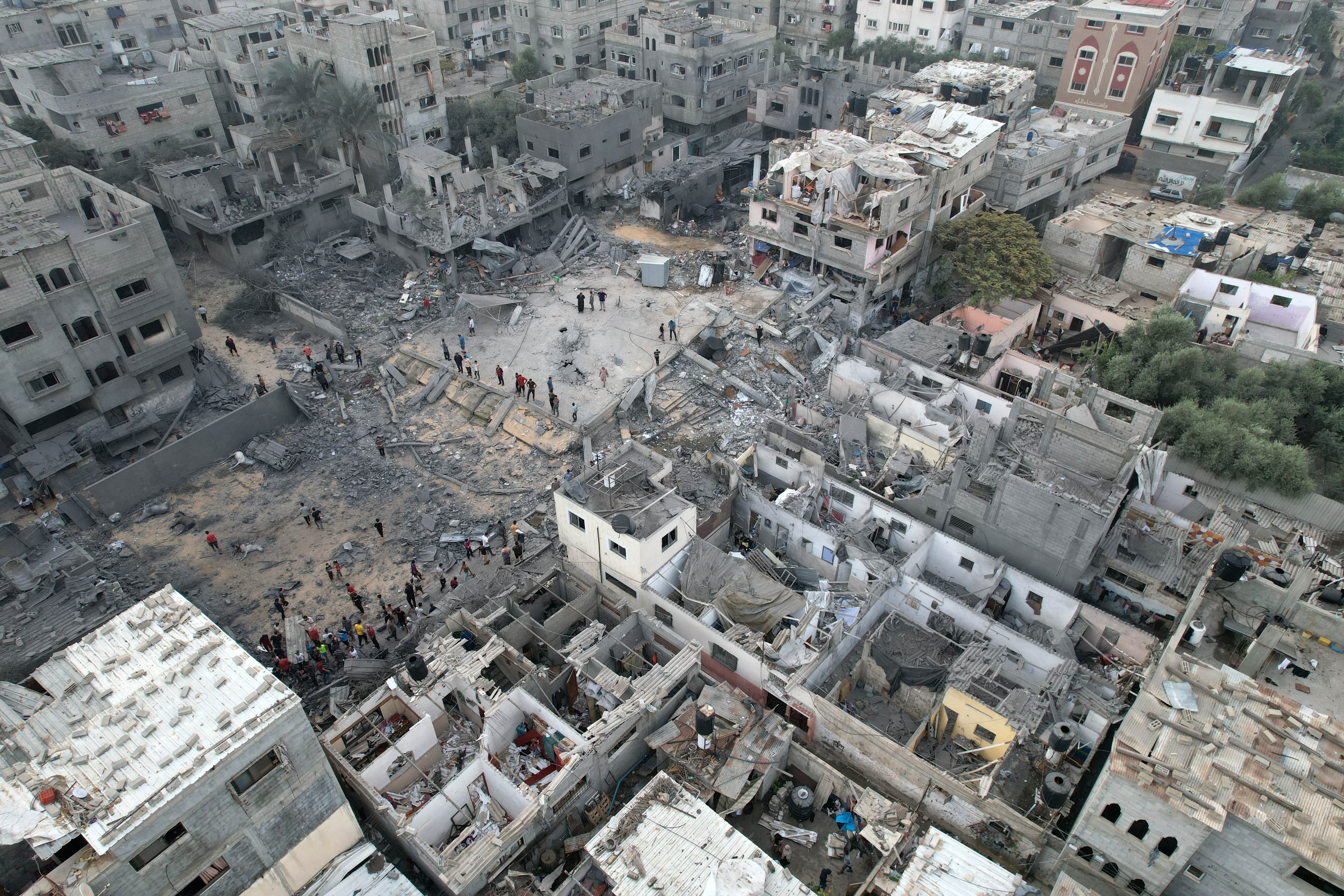 GAZA CITY, GAZA - OCTOBER 29: An aerial view shows civil defense teams and civilians conduct search and rescue operations around Bilal Masjid which was destroyed and the heavily damaged buildings around it after Israeli attacks at Nuseirat Refugee Camp as Israeli attacks continue on the 23rd day in Gaza City, Gaza on October 29, 2023. (Photo by Ashraf Amra/Anadolu via Getty Images)