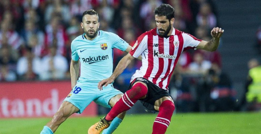 Jordi Alba of FC Barcelona competes for the ball withRaul Garcia of Athletic Club during the La Liga match between Athletic Club Bilbao and FC Barcelona at San Mames Stadium 