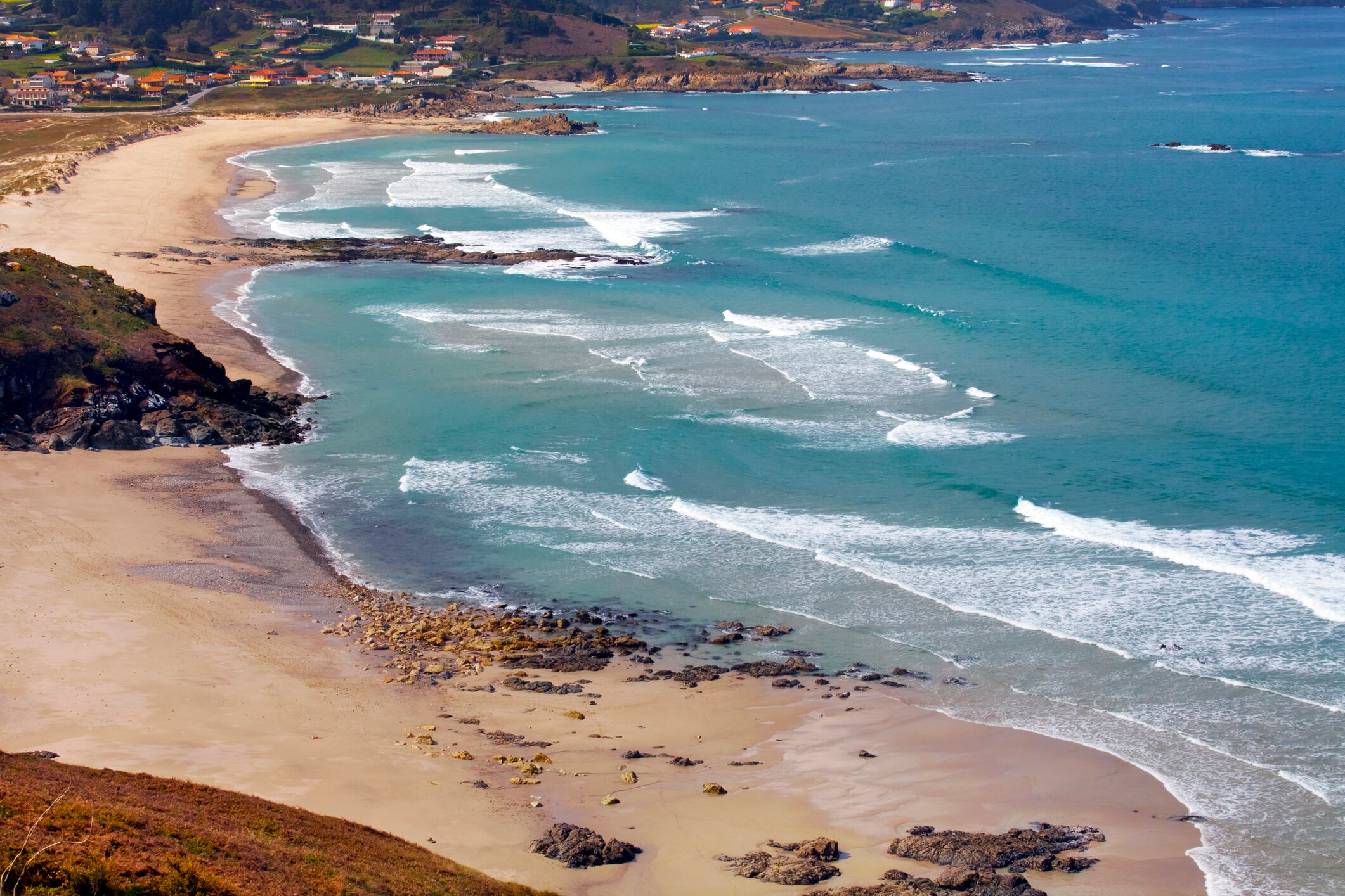 A Coruña coastline, beautiful Barrañán beach in Arteixo, Galicia, Spain. Seascape, sunny beach, breaking waves.