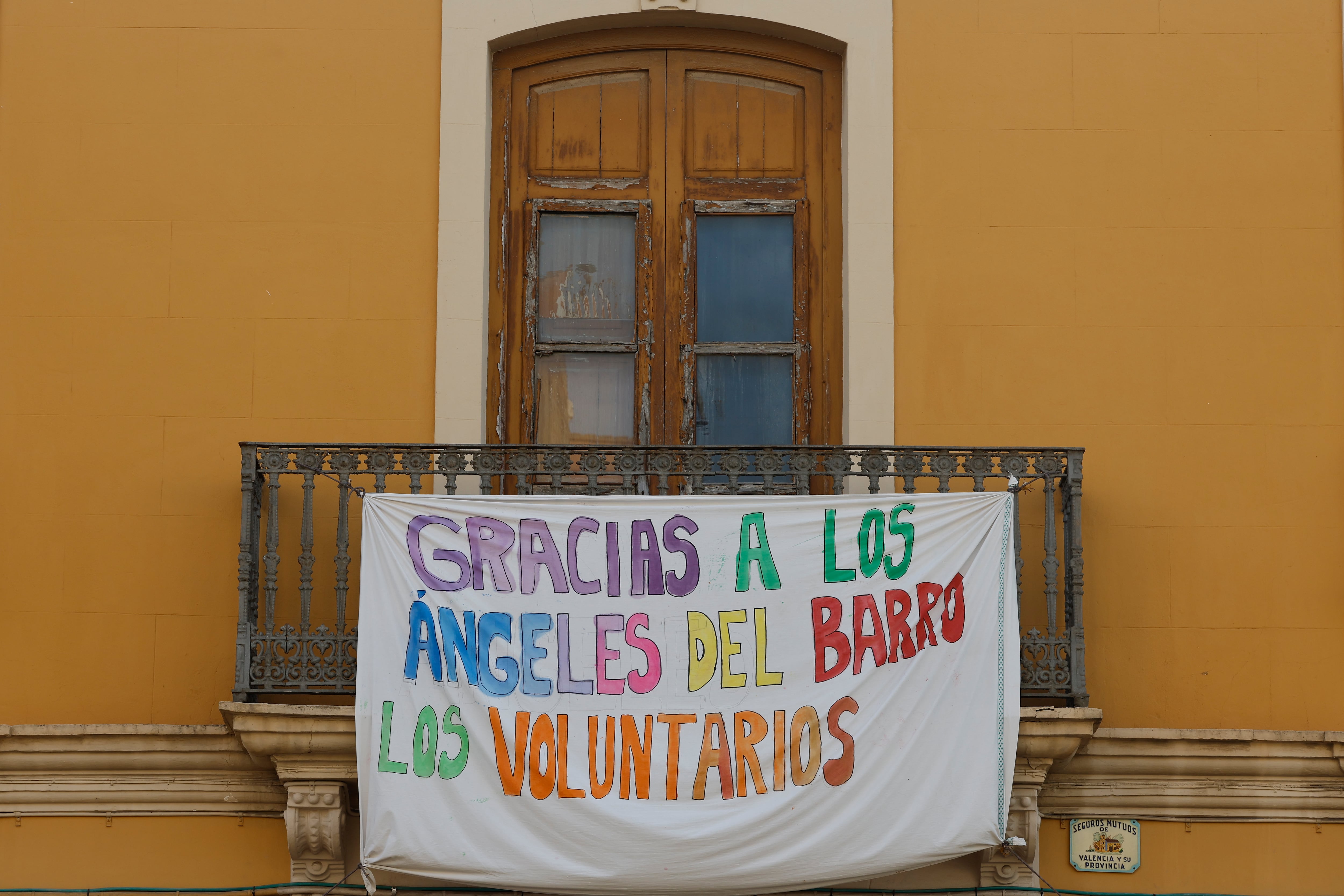 Una pancarta de agradecimiento a los voluntarios cuelga de un balcón de la localidad de La Torre (Valencia).