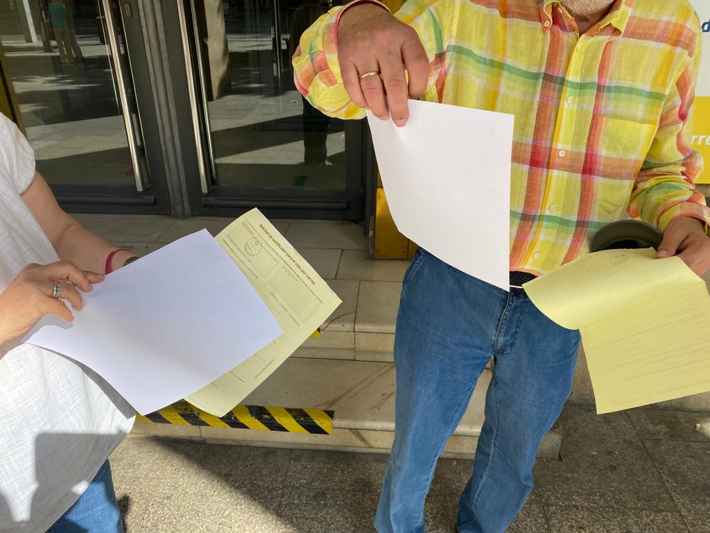 Dos ciudadanos de Zaragoza, en la salida de una oficina de Correos tras solicitar el voto por correo