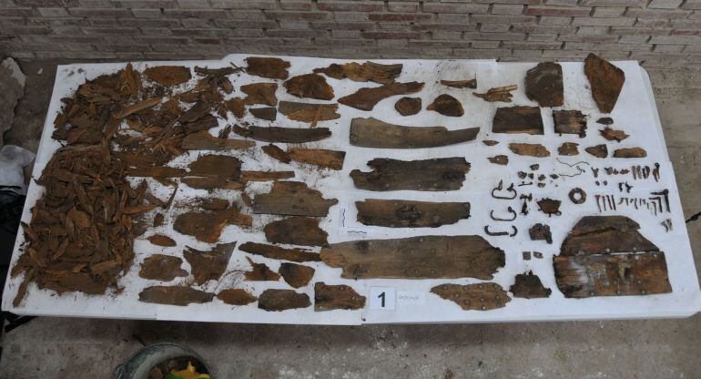 This handout picture released on January 26, 2014 by Sociedad de Ciencia Aranzadi shows corroded metal pieces, rotten wood fragments and a board with the initials MC that could help to confirm the final resting place of the autor of &quot;Don Quixote&quot; the late